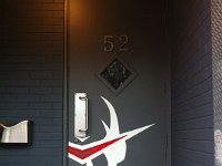 Vector Face  Logo in cut vinyl installed on exterior door